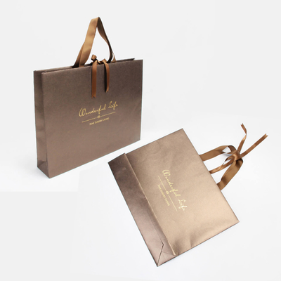 Sacs en papier irisés d'or lumineux sérigraphiant les sacs-cadeaux de papier de Brown